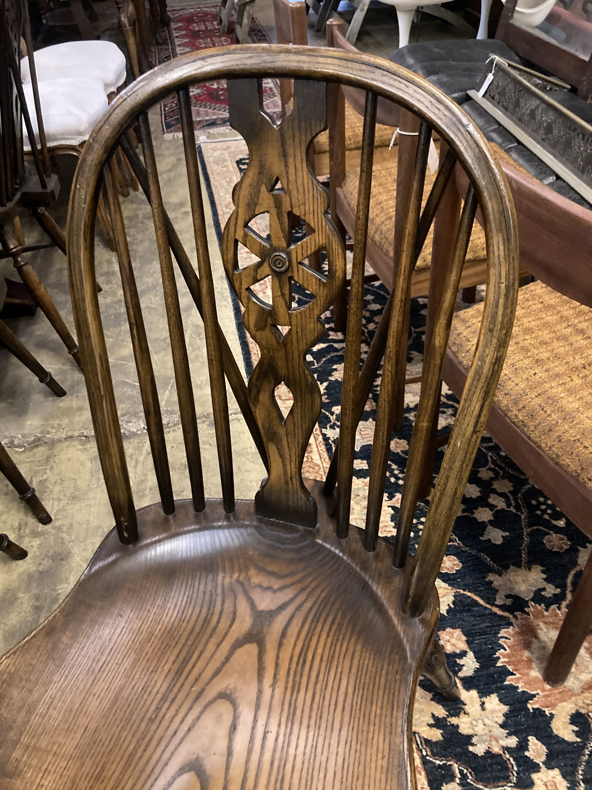 A set of ten stained ash and elm Windsor chairs with crinoline stretchers (two having arms)